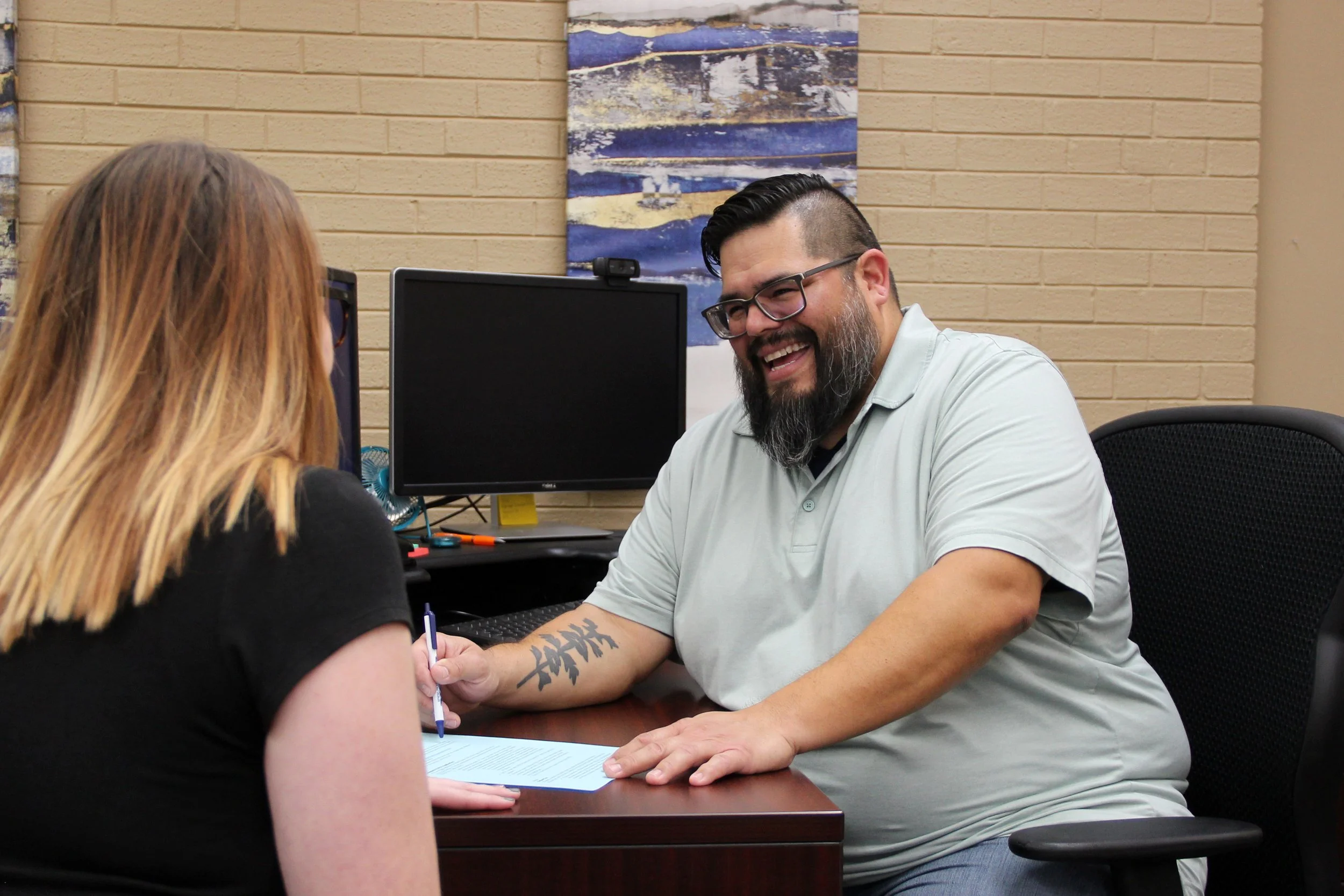 employee helping student in the financial aid office